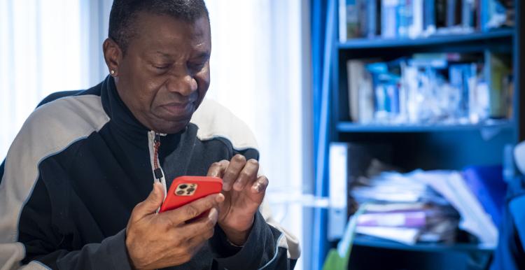 A man looking at a mobile phone 