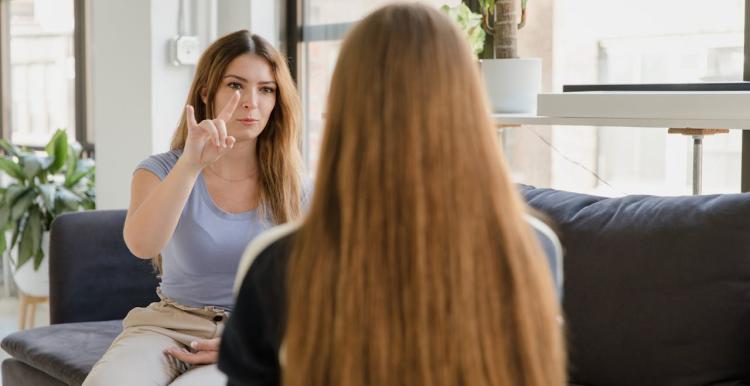 Two women communicating with BSL