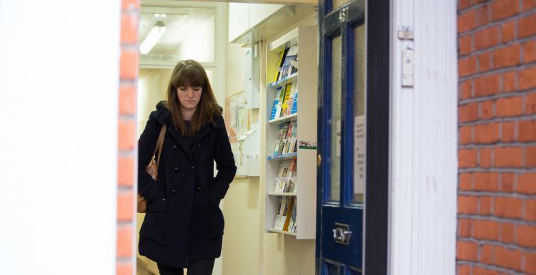 woman walking out of GP surgery