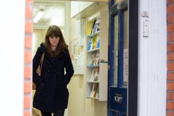 woman walking out of GP surgery