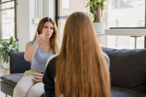 Two women communicating with BSL