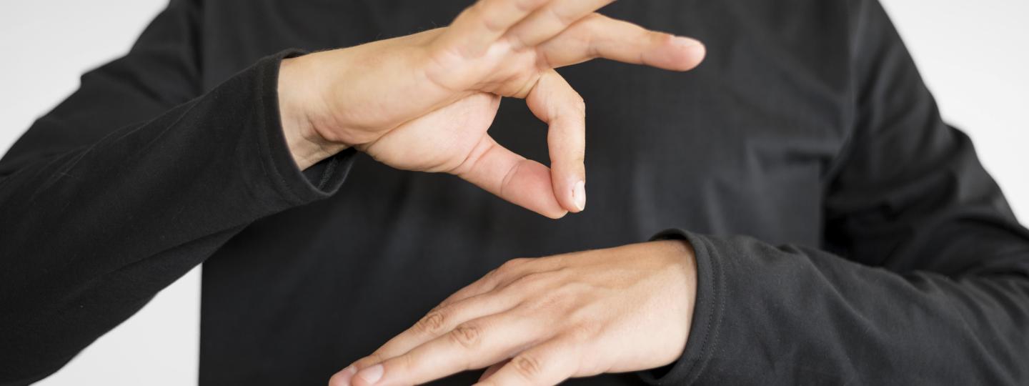 Close up of hands - someone using sign language 